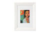 Framed artwork with a colorful portrait of a woman on a white background