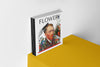 Product photograph of an art cover sketchbook FLOWERY by Nemozine, featuring a stylized portrait of Van Gogh with floral design, displayed on a vibrant yellow platform against a clean white wall.