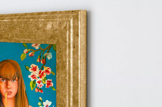 oil painting of a woman eating spaghetti with an aqua blue floral background, mounted in a Golden wooden frame on a white wall