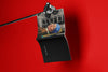 Product lifestyle photograph of an art cover sketchbook featuring the GIRL WITH A PEARL EARRING portrait reinterpeted by Nemozine, suspended against a vibrant red background