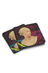 Product photograph of two square coasters stacked at an angle, featuring a stylized graphic design of a classic marble bust combined with vibrant neon pink Japanese kanji and bright yellow caution tape elements, isolated against a clean white background.