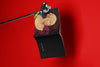 Product lifestyle photograph of an art cover sketchbook featuring the IDEAL FEMALE HEAD 'IFH A' portrait design by Nemozine, suspended against a vibrant red background.