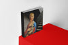 Product photograph of an art cover sketchbook featuring the LADY WITH AN ERMINE in a monochrome setting by Nemozine, displayed on a vibrant red platform against a clean white wall.