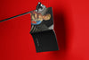 Product lifestyle photograph of an art cover sketchbook featuring the LADY WITH AN ERMINE reinterpratation portrait design by Nemozine, suspended against a vibrant red background.