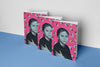 Product photograph of three art cover sketchbooks featuring a portrait of a child on a bright pink background adorned with ant and yellow dot patterns, displayed on a vibrant blue surface against a clean white wall.