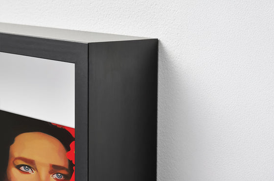 Close-up of a black shadow box framed portrait painting on a white wall