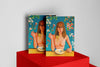 Product photograph of two art cover sketchbooks featuring a portrait design of a woman eating noodles surrounded by floral elements, displayed on a vibrant red platform against a clean white background.